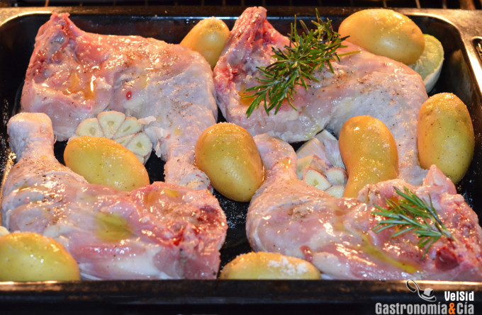 Pollo al horno con patatas, ajo y romero