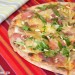 Pizza de carpaccio, rúcula y piñones