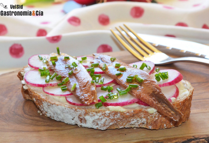 Tostadas con mantequilla, sardinas anchoadas y rabanito